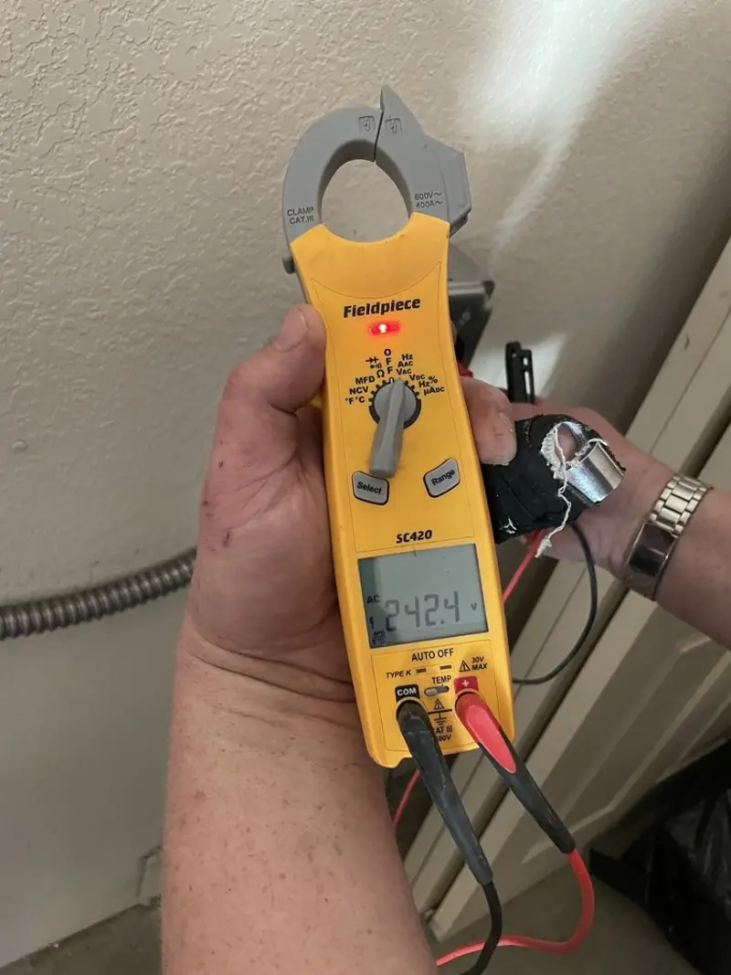 Voltage testing with clamp meter during Ceiling Fan Installation in Asbury Lake